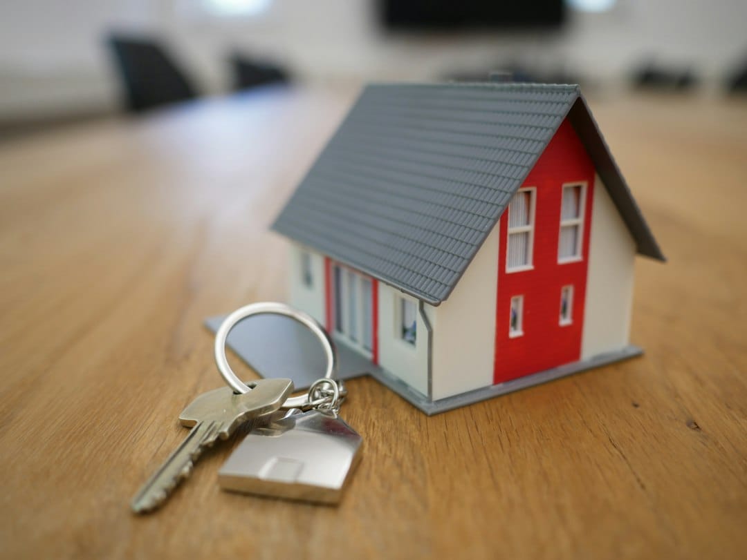 Miniature house on a desk illustrating an England and Wales property sale contract